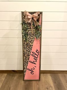 a leopard print door hanger with pink ribbon