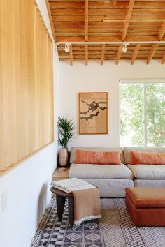 the living room is clean and ready for us to use it's natural wood ceiling