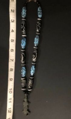 Very Very Old! Antique African AKAN/ASHANTI Necklace Crocodile Pendant with mixed beads. One is an old feather, black and white bead. One looks hand painted black & white. There are several blue/black beads that look Venetian. There are also many smaller black, ribbed round beads with white edge. Crocodile is made of sold brass. He's approx 2 inches. Necklace Choker is approx 12 inches. Ashanti also known as Asante, are part of the Akan ethnic group and are native to the Ashanti Region of mo Spiritual Wooden Beads, Traditional Long Necklace With Black Beads, Traditional Long Beaded Necklace With Black Beads, Traditional Turquoise Wooden Beads, Traditional Blue Wooden Beaded Necklaces, Traditional Blue Wooden Beads, Traditional Blue Jewelry With Wooden Beads, Artisan Black Beaded Necklaces For Jewelry Making, Unique Blue Wooden Beaded Necklaces