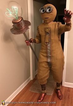 a person in a costume holding a light bulb