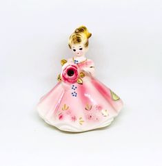 "Josef Originals Girl figurine, A charming girl holds a Rose flower with Garnet rhinestone center. She wears a pretty pink dress with embossed flowers & gold details. Perfect for a gift or collect for yourself! January Lady. Measures: 4.25\" tall x 4\" wide. Condition: Very good vintage condition. No chips or cracks. Signed on bottom. Original January sticker on dress. Please visit our shop to view our entire vintage selection at DartmouthHill: https://www.etsy.com/shop/DartmouthHill?ref=hdr_sho Pretty Pink Dress, Pink Vanity, Josef Originals, Rabbit Decor, Bunny Decor, Porcelain Roses, Lipstick Holder, Vintage Jewelry Box, Victorian Art