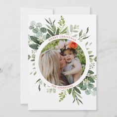 a christmas card with an image of a woman holding a baby