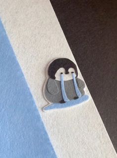 a close up of a paper with a penguin on it