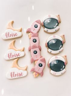 decorated cookies with the words please please and an astronaut's eye on them are arranged in rows