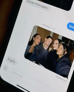 an iphone screen with the message love on it and three women taking a selfie