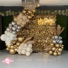 balloons are arranged in the shape of a house with gold, silver and white decorations