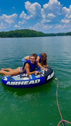 two people on an inflatable boat floating on the water