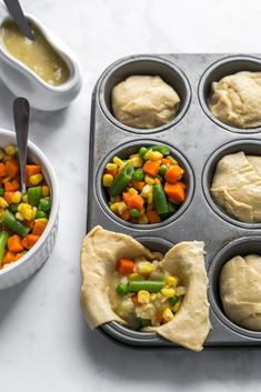 a muffin tin filled with different types of food next to bowls and spoons