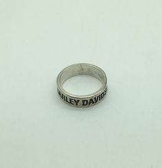 Men's Harley Davidson Shield Sterling Silver Ring Band Mexico  925 Motorcycle  Size 13.5  Great gift idea for the Biker . Vintage , Preowned ring. Light wear on 2 letters ( ON) Made In Mexico Approx 10.6 grams Approx 5/16" wide Original patina intact . Silver Rings With Engraved Logo For Anniversary, Silver Round Jewelry With Engraved Logo, Silver Jewelry With Engraved Logo, Classic Anniversary Jewelry With Engraved Logo, Silver Ring Band, Sterling Silver Rings Bands, Ring Light, Silver Band Ring, Ring Band