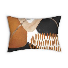 an orange and black pillow with a woman's hand on it, against a white background