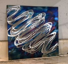 a blue and silver art piece sitting on top of a counter