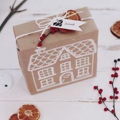 an orange slice is sitting on top of a cardboard box with a house drawn on it