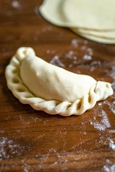 an uncooked pastry sitting on top of a wooden table