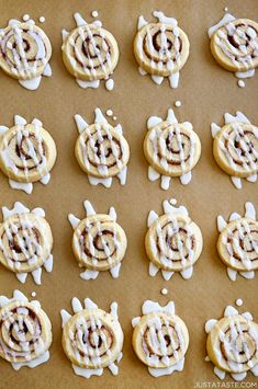 there are many cookies with white icing on the top and one has an image of a turtle