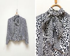 "Vintage 90s Animal Print Blouse Black And White Patterned Blouse Long Sleeve Blouse Bow Tie Blouse Blouse With Bow Leopard Blouse Bow L XL D E S C R I P T I O N: 🖤 lightweight 🖤 leopard print 🖤 8 buttons closure 🖤 front tie ⛔️PLEASE NOTE: the blouse has very small hole in front, but it's not visible because of pattern, look at the last picture!⛔️ Brand: RIO Suggested size: 44, look's like women's L-XL or oversize - to ensure a good fit, please check the below measurements carefully Material Spring Leopard Print Ruffled Blouse, Zara Animal Print Blouse, Leopard Print Button-up Top For Work, Blouse With Bow, Kids Outfits Daughters, Summer Leopard Print V-neck Blouse, Patterned Blouse, Bow Tie Blouse, Leopard Blouse