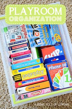 a plastic container filled with lots of books on top of a carpeted floor and the words playroom organization written above it