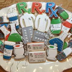 decorated cookies are arranged in the shape of letters that spell rrrx on a plate