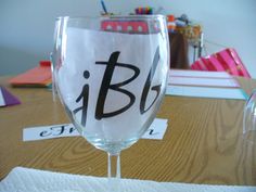 a wine glass sitting on top of a wooden table