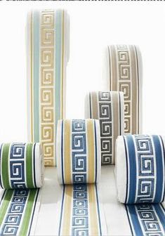 four rolls of decorative tape with greek designs