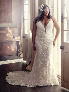 a woman in a wedding dress posing for the camera