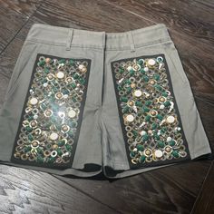 These Beautiful Couture Army Green Jeweled And Sequined Shorts Make A Glistening Statement! Walk Into A Room And Light It Up Like A Disco When Catching The Light. Embellishments: White, Emerald Green And Olive Green Beads With Gold And Silver Sequins And Mirrored Rhinestones. Authentic Prada Size 40 Eu Us Size 6 Waist Is 28" High-Waist Design Zip Up With Double Flat Hook And Eye Closures And Button For Extra Anchoring. 3 Front Pocket Design 2 Button Backside Pockets 6 Belt Loops These Are Absolu Front Pocket Design, Sequin Shorts, Green Beads, High Waist Shorts, High Waisted Shorts Denim, Silver Sequin, Green Bead, High Waisted Denim, Pocket Design