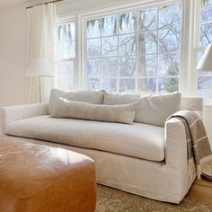 a living room filled with furniture and a large window