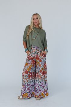 Elevate your boho wardrobe with the Blissful Burst Floral Pants - with their trendy wide legs and comfortable fit, you'll feel stylish and confident in any setting! Boho fabric that drapes beautifully and adds a touch of texture Bold floral print for an eye-catching look Palazzo silhouette with flared wide legs for a relaxed and breezy feel Thick smocked elastic waistband for good fit Convenient side seam pockets Pair with: Sophie Crochet Lace Bralette, On The Go V Neck Ribbed Essential Tee and Hawaii Outfit Ideas, Hawaii Outfit, Island Chic, Boho Essentials, Bralette Outfit, Bold Floral Print, Boho Fabric, High Hopes, Boho Chic Outfits