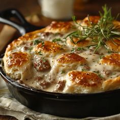 a casserole dish with meatballs and gravy in a cast iron skillet