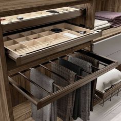 an open drawer in a kitchen with folded towels