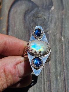 This statement piece is Indian Moonstone and Brazilian blue kyanite! Such a beauty, sterling silver, size 8 with a quad-split band! Handmade Blue Moonstone Ring For Healing, Unique Blue Labradorite Ring, Blue Moonstone Ring With Natural Stones, Blue Moonstone Ring With Accent Stones, Blue Oval Moonstone Ring, Unique Moonstone Ring With Accent Stones In Sterling Silver, Blue Labradorite Moonstone Ring, One-of-a-kind Oval Moonstone Ring In Sterling Silver, Unique Blue Moonstone Ring With Natural Stones