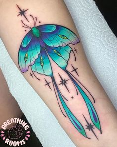 a blue butterfly with stars on its wings is sitting on someone's leg and has the words breathing roots written below it