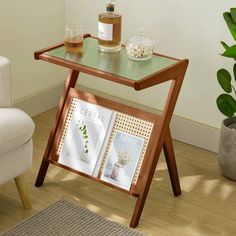 a wooden table with two magazines on it and a bottle of alcohol next to it