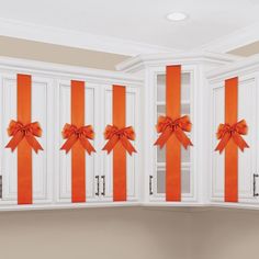 orange bows on white cabinets in a kitchen