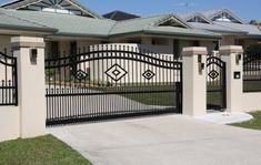 an iron gate is in front of a house