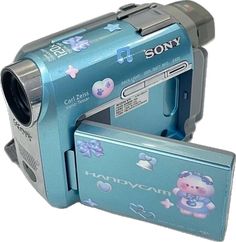 an image of a video camera with its case open and it's flash drive attached