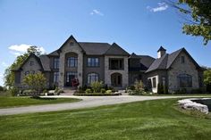 a large house with lots of windows and landscaping