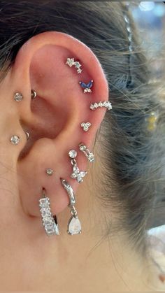 a woman with multiple ear piercings on her ears