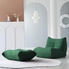 a green bean bag chair sitting on top of a white rug in a living room