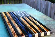 an american flag made out of wood sitting on top of a table