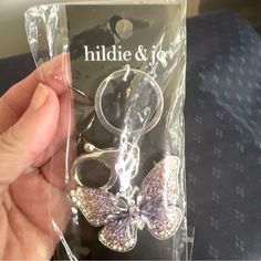 This Beautiful Hildie & Jo Keychain Features A Charming Butterfly Design With Sparkling Rhinestones. The Purple Color Adds A Pop Of Color To Any Outfit And Is Perfect For Those Who Love Unique Accessories. The Keychain Is Small In Size, Making It Convenient To Carry Around Wherever You Go. Ideal For Women Who Love To Add A Touch Of Whimsy To Their Outfits, This Keychain Is A Must-Have For Any Hildie & Jo Fan. The Brand Is Known For Its High-Quality Accessories That Are Both Stylish And Functiona Purple Keychain, Butterfly Keychain, Butterfly Rhinestone, Workout For Flat Stomach, Purple Bag, Unique Accessories, Flat Stomach, Cute Keychain, Key Card Holder