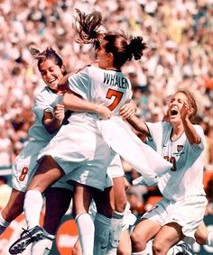 the women's soccer team is playing against each other in front of an audience