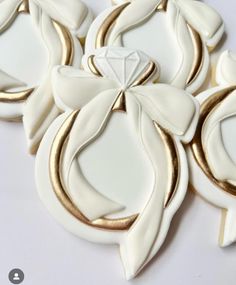 some white and gold decorated cookies on a table