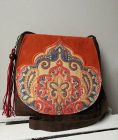 Orange and brown messenger bag Boho bag Vegan crossbody bag Oriental bag Medium sized bag Oriental purse Evening bag Christmas gift idea -Medium sized messenger bag with adjustable strap -Simple style -Flap with decorative badge -Inside lining with two pocket -Bag closed by magnet -Bag made from eco suede -Bag decorated with hand-made tassel Width 10,24- 11,81 in / 26- 30 cm height 9,84 in / 25 cm Care: wash in hands and lay flat to dry. Real colors may differ slightly from their appearance on y Medium Size Crossbody Purse, Brown Crossbody Shoulder Bag With Mobile Phone Pocket, Brown Crossbody Shoulder Bag With Removable Pouch, Brown Satchel Backpack With Mobile Phone Bag, Brown Crossbody Flap Bag With Removable Pouch, Rectangular Brown Hobo Bag For Gift, Brown Satchel Flap Bag With Removable Pouch, Brown Satchel Shoulder Bag With Mobile Phone Pocket, Brown Pouch Flap Bag For Daily Use