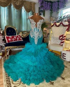 a dress on display in front of a christmas tree and other holiday decorating items