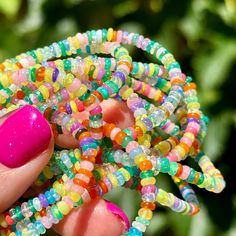 a hand holding a bunch of colorful beads