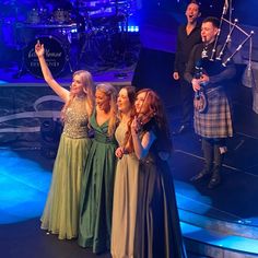 a group of people standing on top of a stage