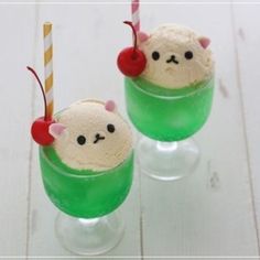 two glasses filled with ice cream and topped with cherries