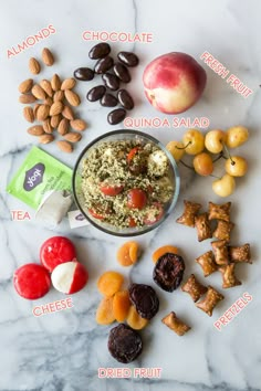 an assortment of fruits and nuts on a marble counter top with the names of their ingredients