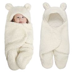 a baby wrapped in a white bear blanket