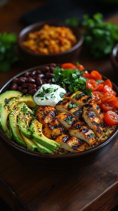 a bowl filled with lots of different types of food on top of a wooden table